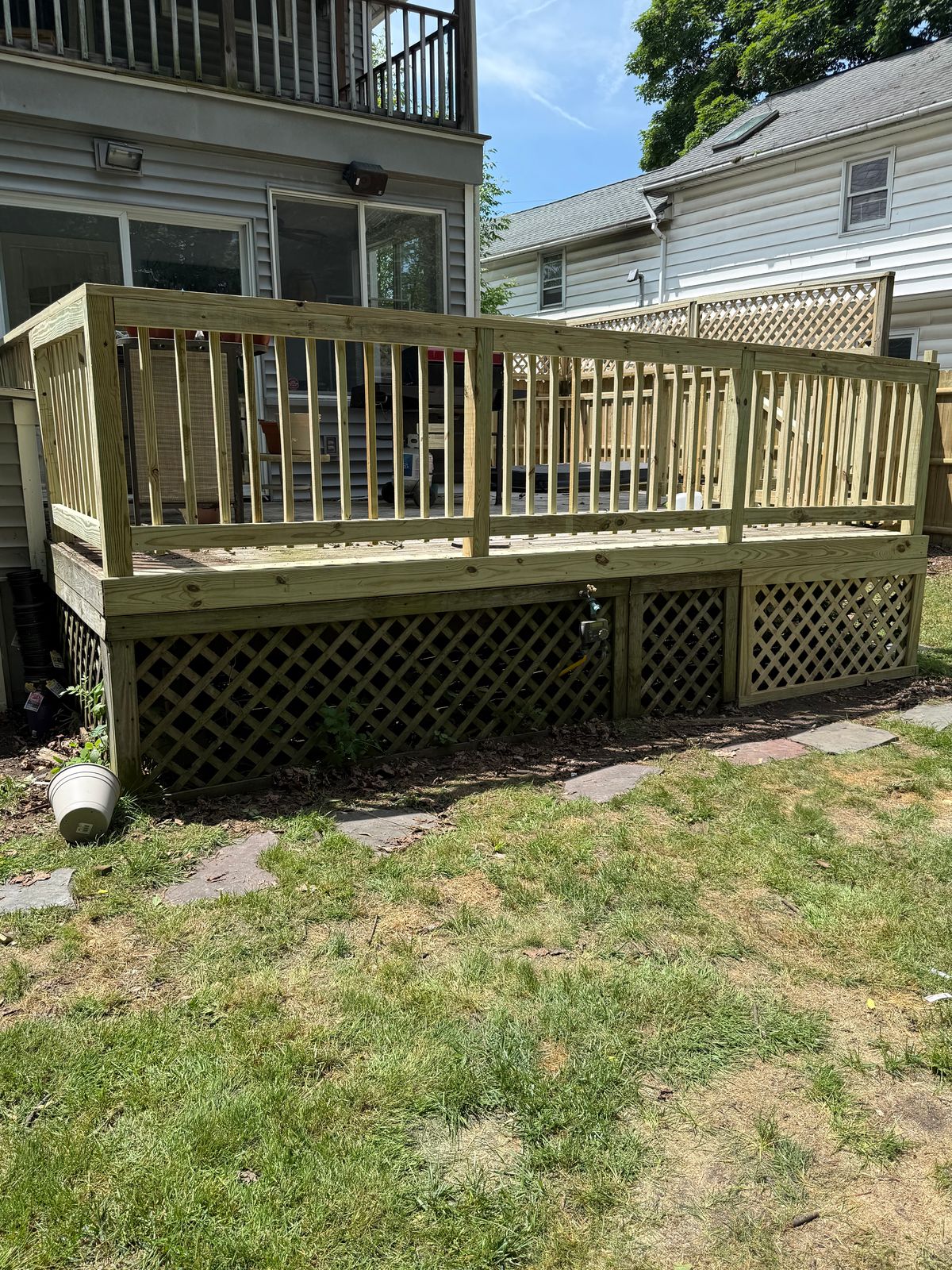 Pressure-treated deck with railings and lattice skirting