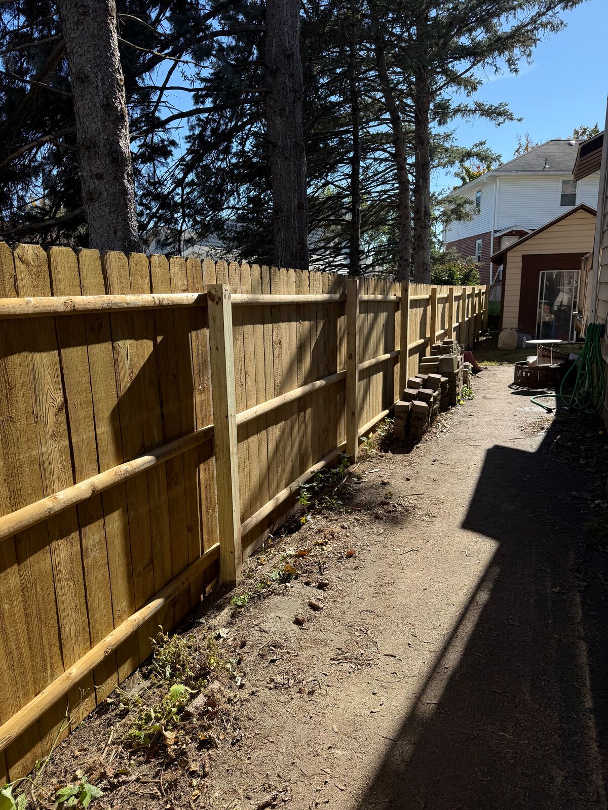 Wood privacy fence along a narrow side yard
