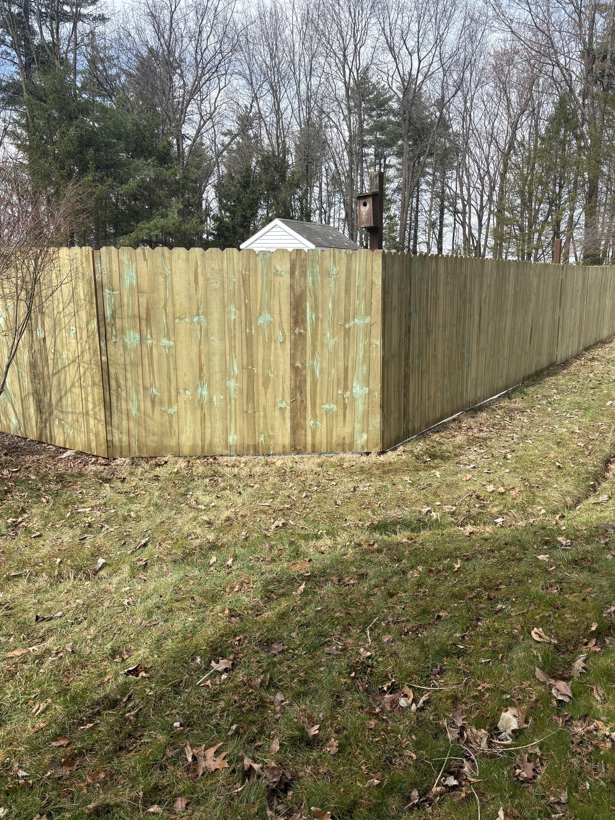 Wood privacy fence wrapping a yard corner
