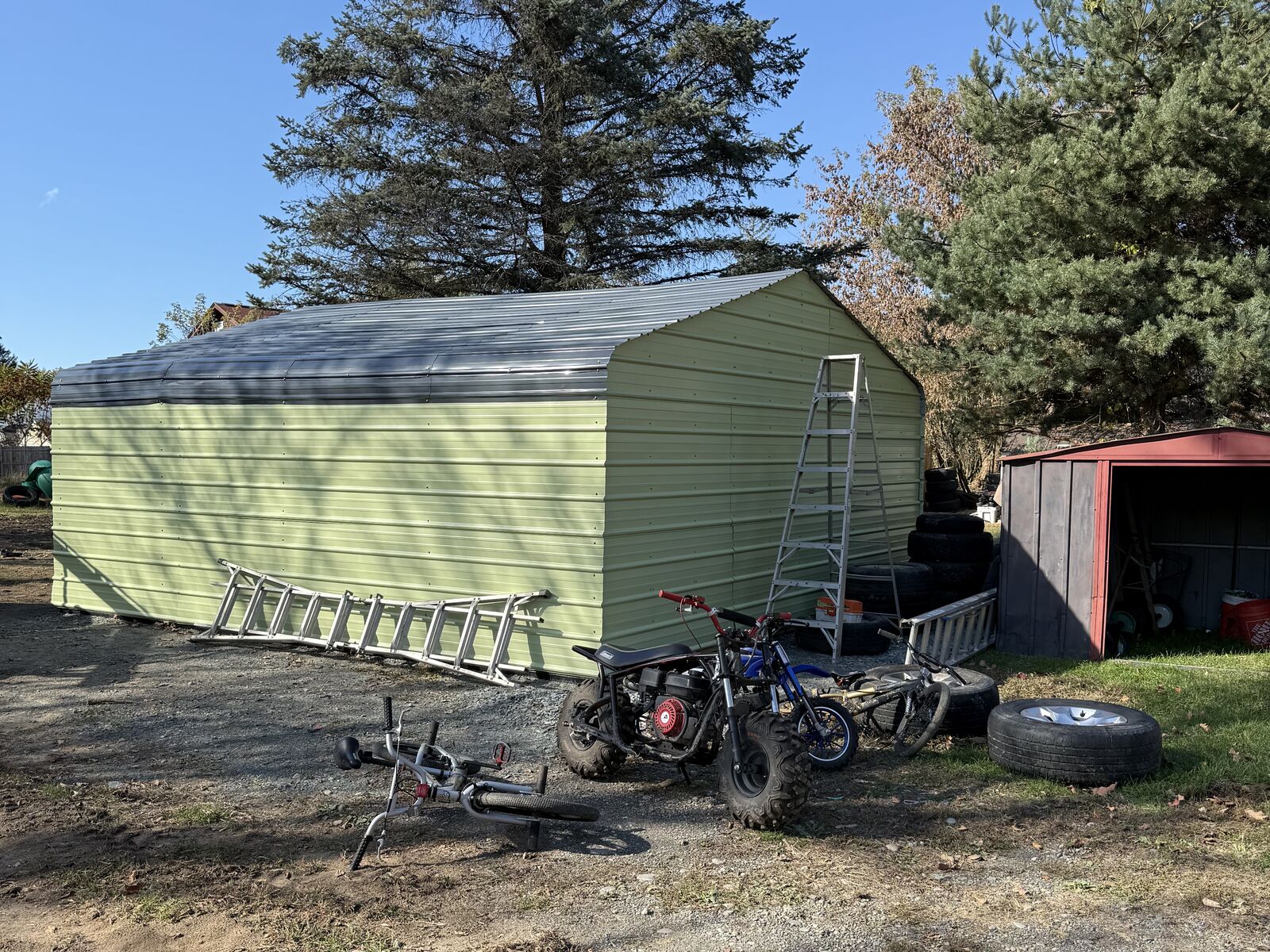 Metal carport closed in with green metal siding