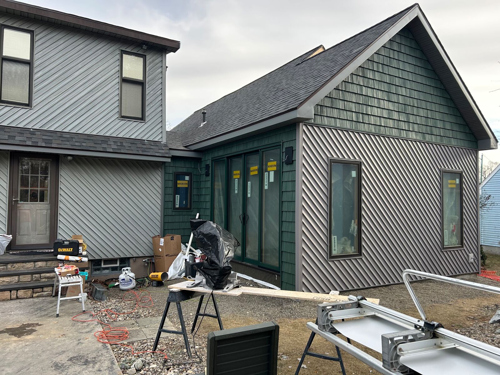 Gray siding with dark green shake-style gables